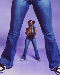 a woman is standing in front of her jeans