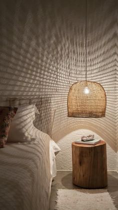 a bed room with two beds and a lamp on top of the headboard next to each other