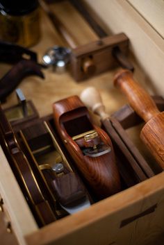 an open wooden box filled with different types of woodworking tools in it's drawers