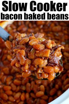 slow cooker bacon baked beans in a white bowl with a spoon full of them