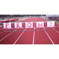 a red track with the word prom written on it in front of an empty stadium