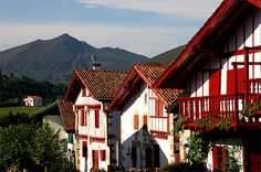 red and white houses with mountains in the background