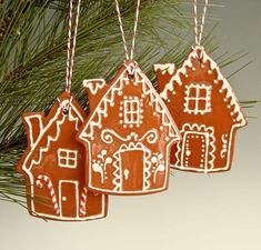 three gingerbread ornaments hanging from a christmas tree