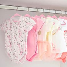 several baby ones hanging on a clothes rack