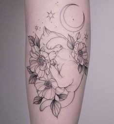 a woman's leg with flowers and a pig tattoo on the side of her thigh