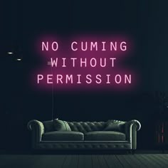 a neon sign that says no cuming without permision on the wall next to a couch