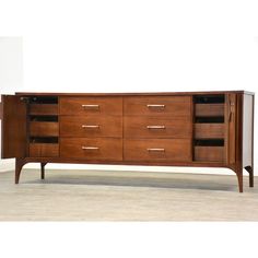 a wooden sideboard with several drawers on it