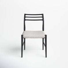 a black chair with a white seat and back rest on a white background, it appears to be empty