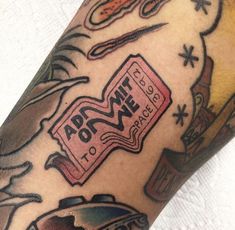 a close up of a person's arm with tattoos on it