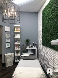 a room with a bed, shelves and plants on the wall