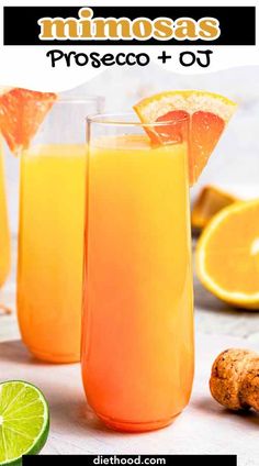 two glasses filled with orange juice and garnished with an orange slice on the side