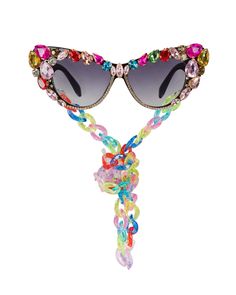 Prepare to exude glamour with these rhinestone face sunglasses, ensuring you feel effortlessly fabulous! Crafted with plastic frames these flamboyant cat-eye shaped polycarbonate lenses feature all-over hand embellishment with firmly applied, prong-set rhinestones.  From light to dark tinted lenses, these sunglasses also feature colorful removable plastic chain neck straps that perfectly match the stems. Each pair is as unique as you are, with assorted stones and chain links, guaranteeing you'll Dramatic Sunglasses, Carnival Parade, Rhinestone Face, Eye Wear, Cool Sunglasses, Neck Chain, Eye Shapes, Neck Strap, Color Crystal