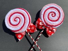 two red and white lollipops sitting on top of each other