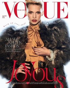 a woman in a fur coat on the cover of a magazine, with her hands on her hips