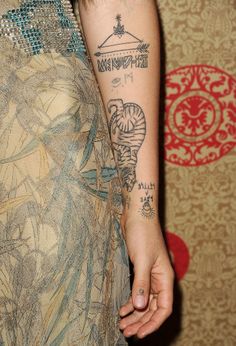 a woman's arm with tattoos on it