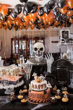 a table topped with halloween decorations and balloons