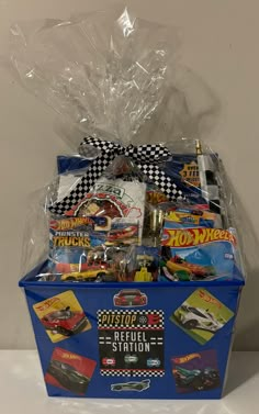 a blue gift box filled with hot wheels toys