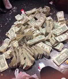 a pile of money sitting on top of a table