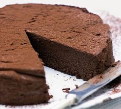 a piece of chocolate cake on a plate with a knife