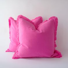 two bright pink pillows with ruffled edges