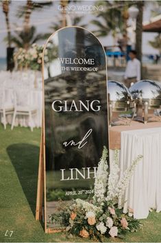 a sign that says, welcome to the wedding and is decorated with flowers on it