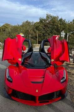 a red sports car with its doors open