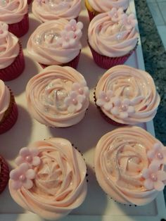 there are many cupcakes with frosting on the top one is pink and white