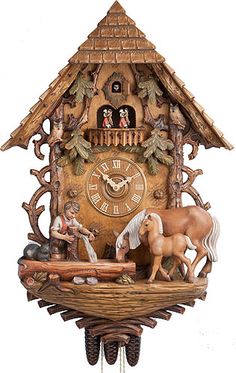 a cuckoo clock with horses and nativity scene