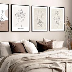 three framed art prints on the wall above a bed