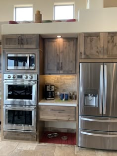 a kitchen with stainless steel appliances and wooden cabinets