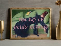 the art of doing nothing is displayed next to two champagne glasses and a framed painting