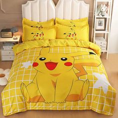 a bed with yellow comforters and pillows on it