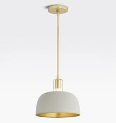 a white and gold pendant light hanging from a ceiling fixture with a circular shade over it