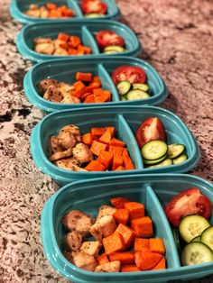 four blue bowls filled with different types of veggies on top of a counter