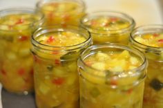 several jars filled with food sitting on top of a table