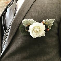 a man in a suit with a flower on his lapel