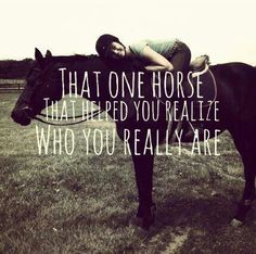 a woman laying on top of a horse in a field with the words, that one horse that red you really are who you really are