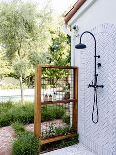 an outdoor shower with plants growing in it