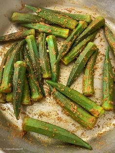 green beans in a pan with seasoning sprinkled on them