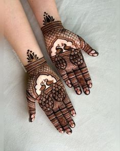 two hands with henna designs on them