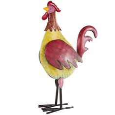 a red and yellow rooster standing on one leg with its head turned to the side