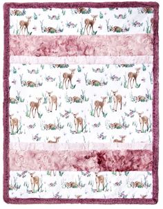 a blanket with deers on it and pink trimming around the edges, in front of a white background