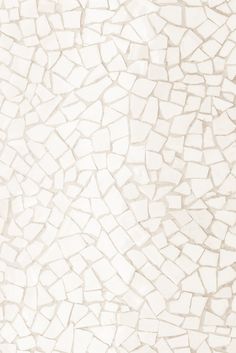 a white and beige wall with small rocks on it's sides, as well as the floor