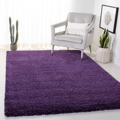 a purple rug in a living room with a chair and potted cacti