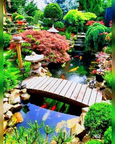 a wooden bridge over a small pond in a garden