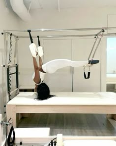 a woman is doing aerial acrobatic exercises