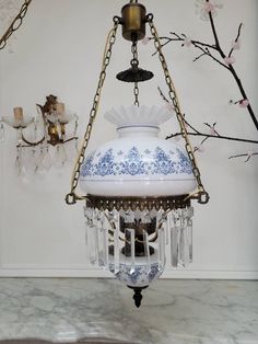 a blue and white vase hanging from a chandelier