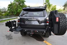 the rear end of a gray toyota truck with its lift kit on it's flatbed