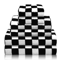 black and white checkerboard towels stacked on top of each other in the shape of a pyramid