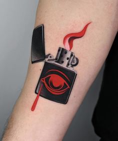 a man with a tattoo on his arm has a lighter and eye drawn on it